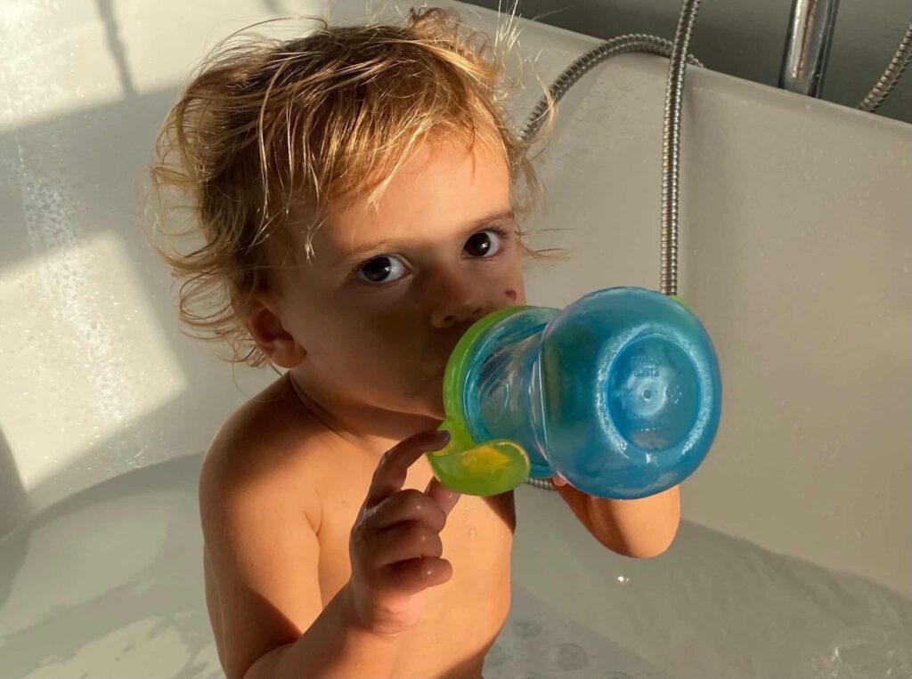 Toddler using a sippy cup