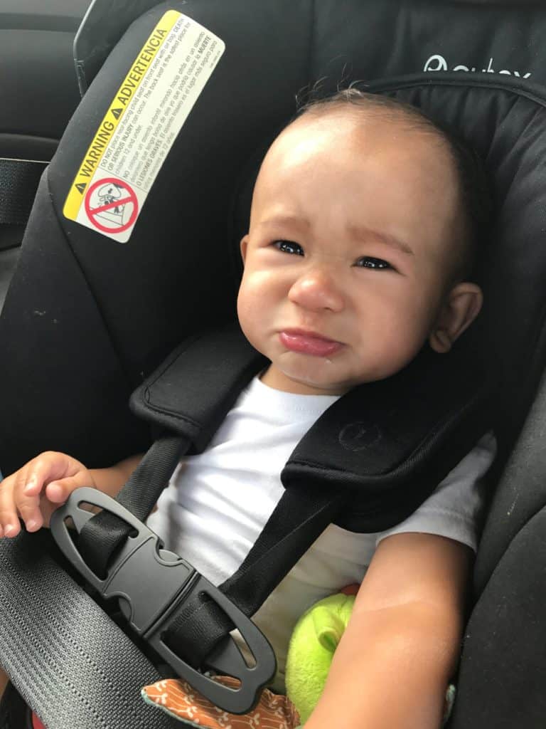 Baby looking upset in carseat
