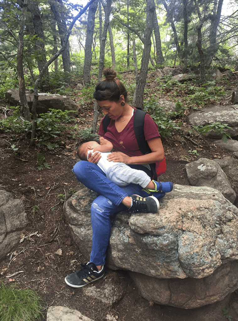 Person breastfeeding amongst trees