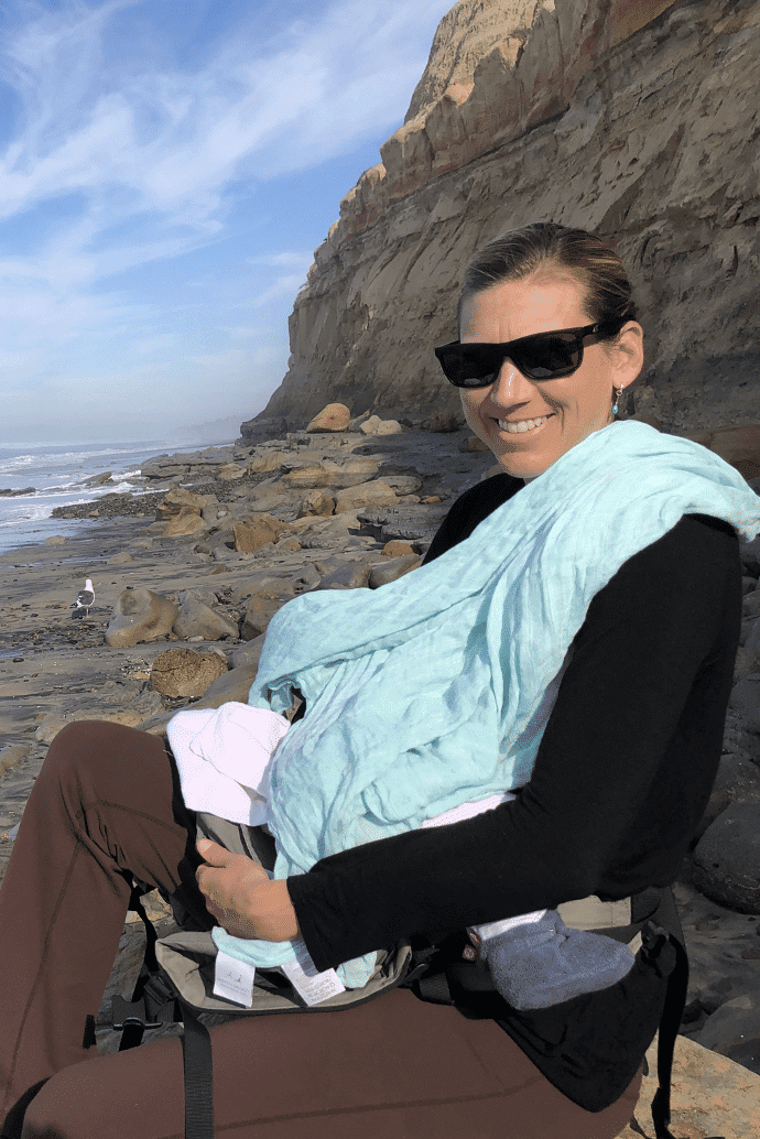 Mother breastfeeding on the beach