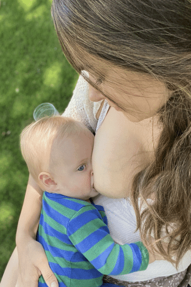 Mother breastfeeding outside