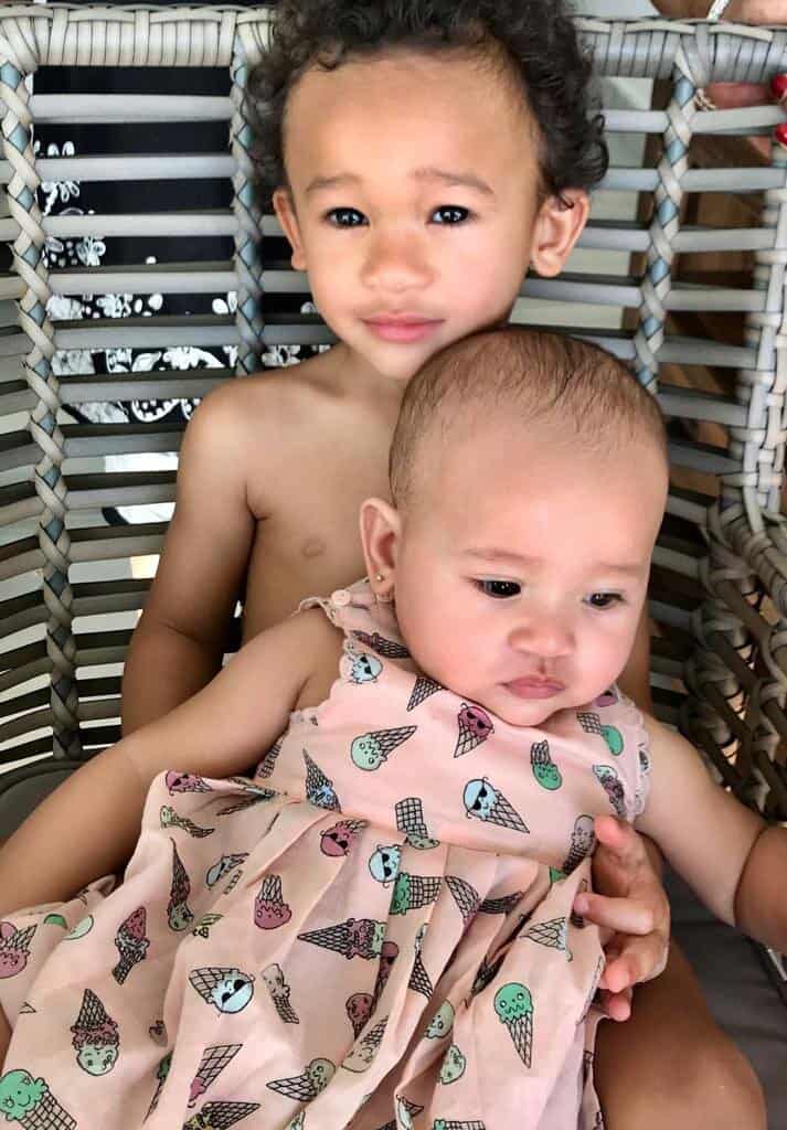 Older child holding younger sibling