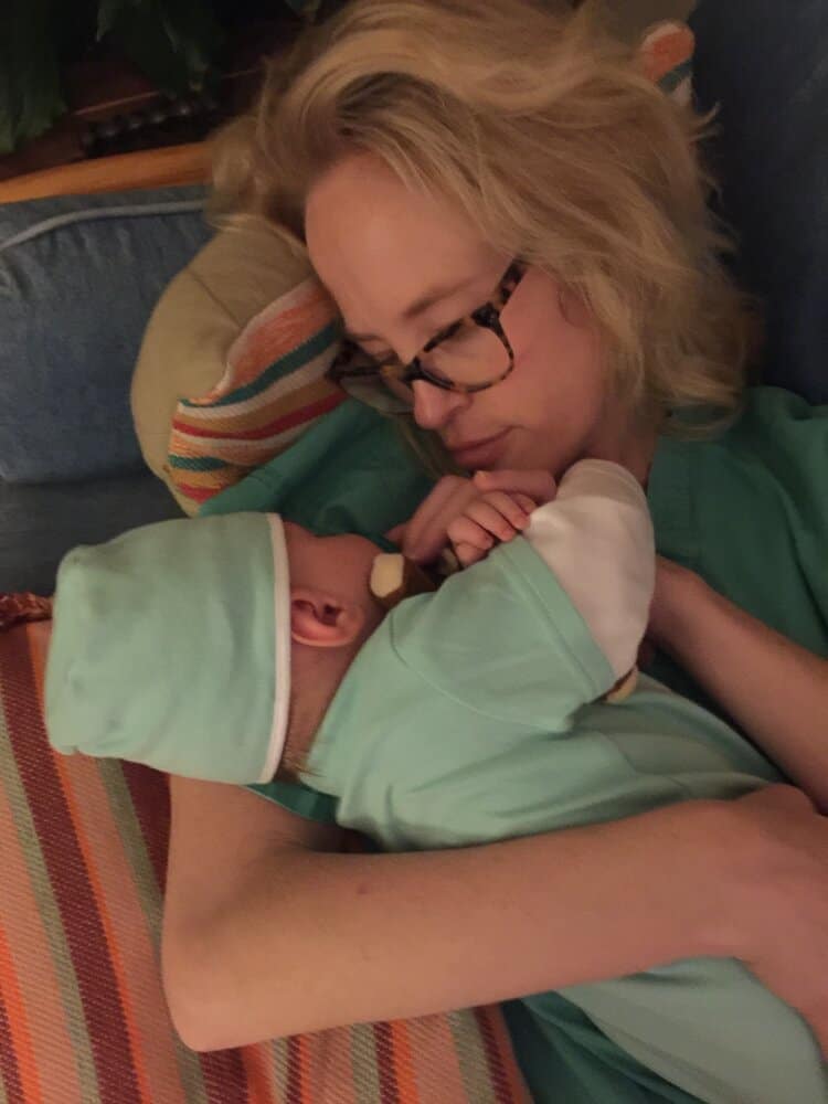 Katrina Mitchell cuddles with her son in bed